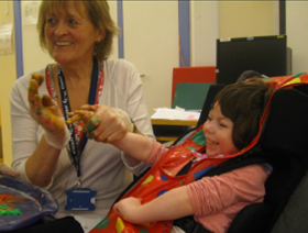 Young Child from the Perseid School Morden with Teacher doing art